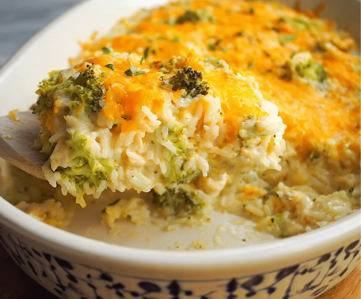Creamy Chicken Broccoli Rice Cheese Casserole topped with melted cheese and fresh broccoli florets, served in a baking dish.