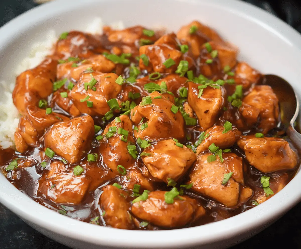 Delicious Crock Pot Bourbon Chicken served with rice and vegetables, featuring tender glazed chicken in a savory bourbon sauce