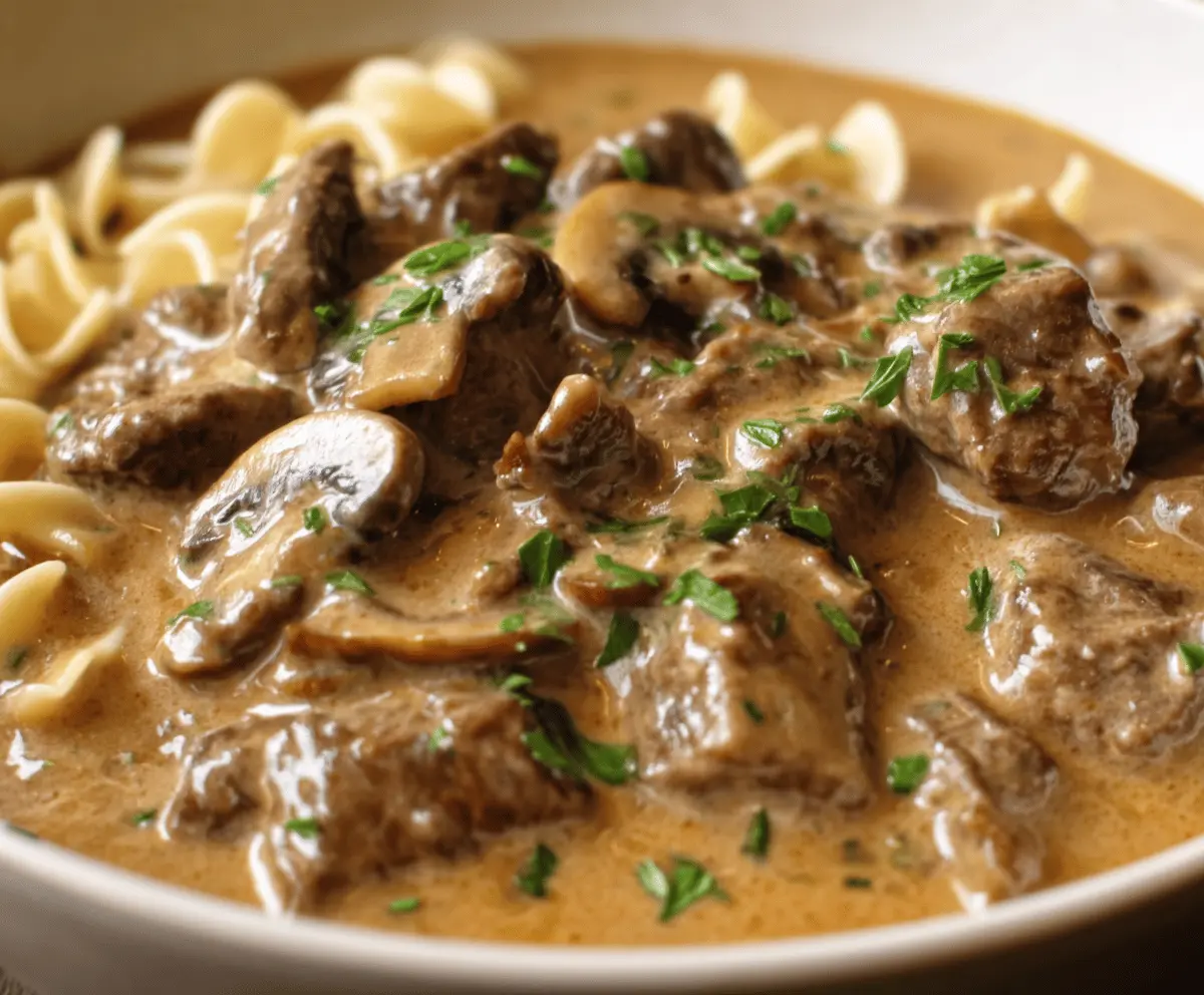 Creamy Gordon Ramsay Beef Stroganoff served with tender beef strips, mushrooms, and rich sauce in a rustic bowl.