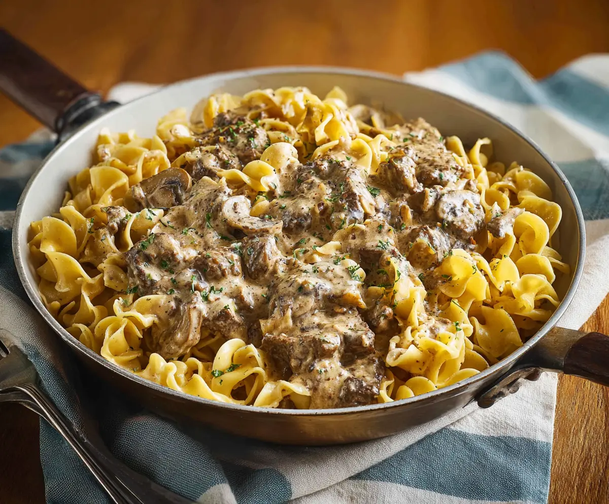 Delicious beef stroganoff served over noodles with creamy mushroom sauce