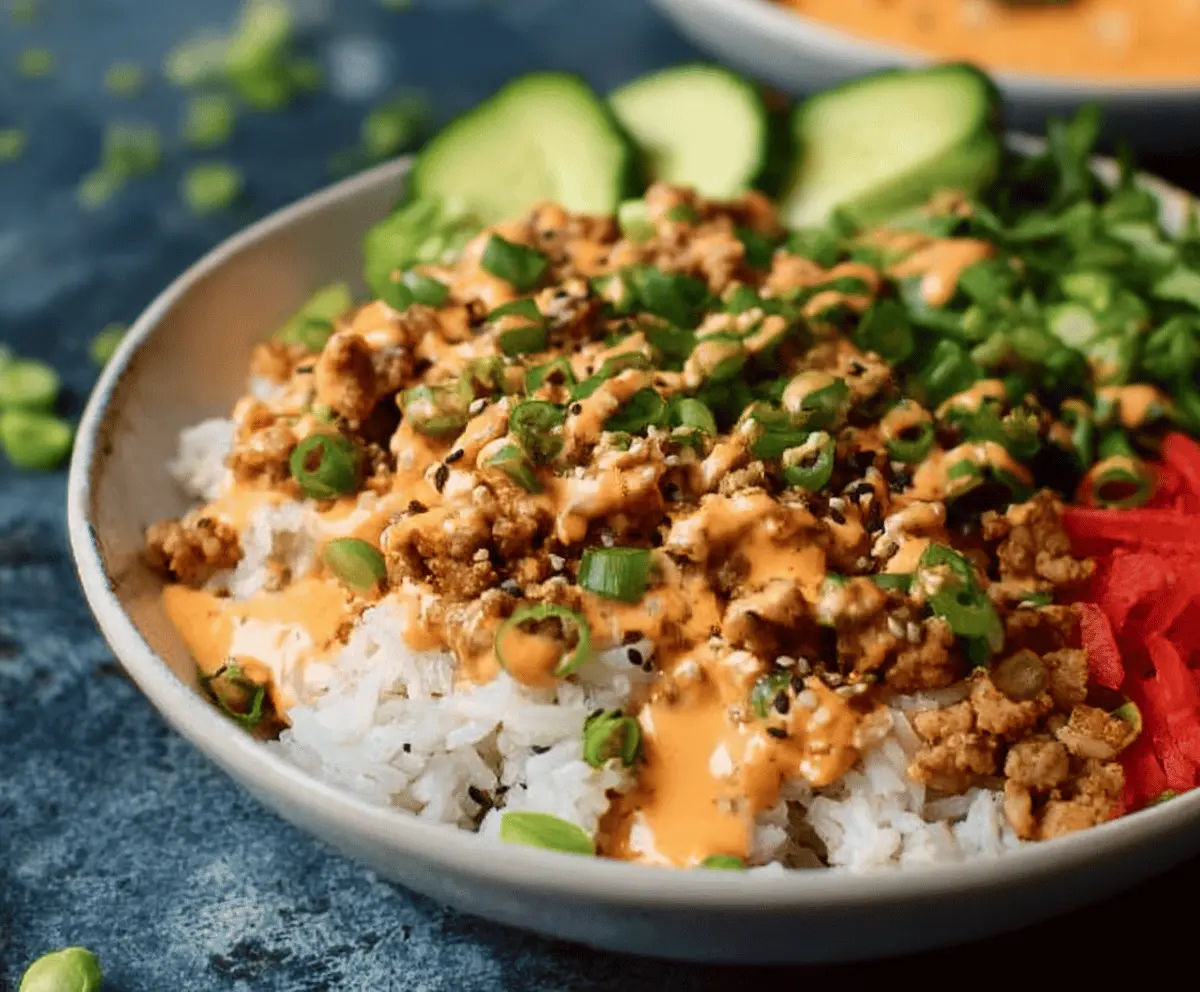 Delicious ground turkey rice bowls topped with colorful vegetables and flavorful Bang Bang sauce.