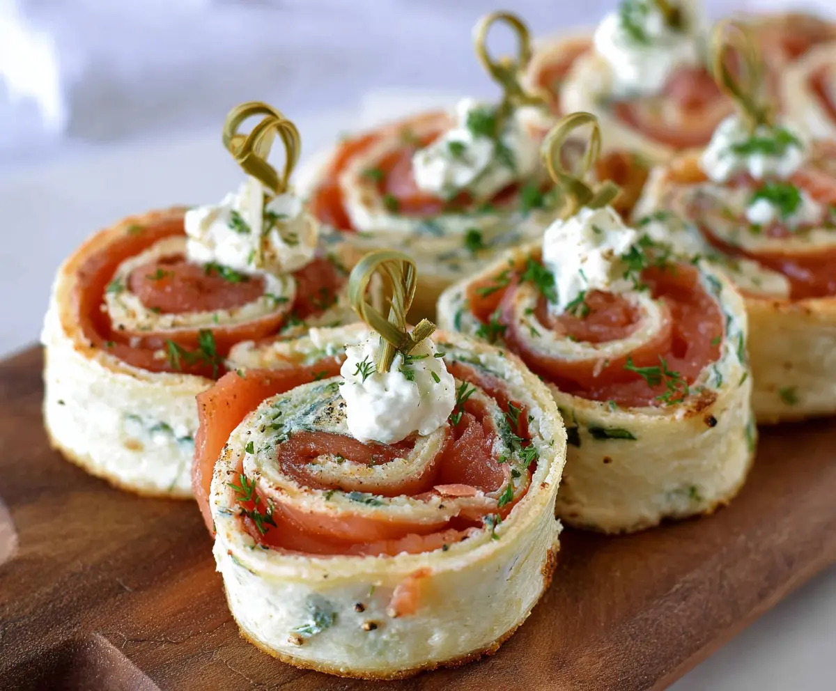 Delicious easy smoked salmon pinwheels served as party appetizers, featuring creamy filling and fresh herbs.